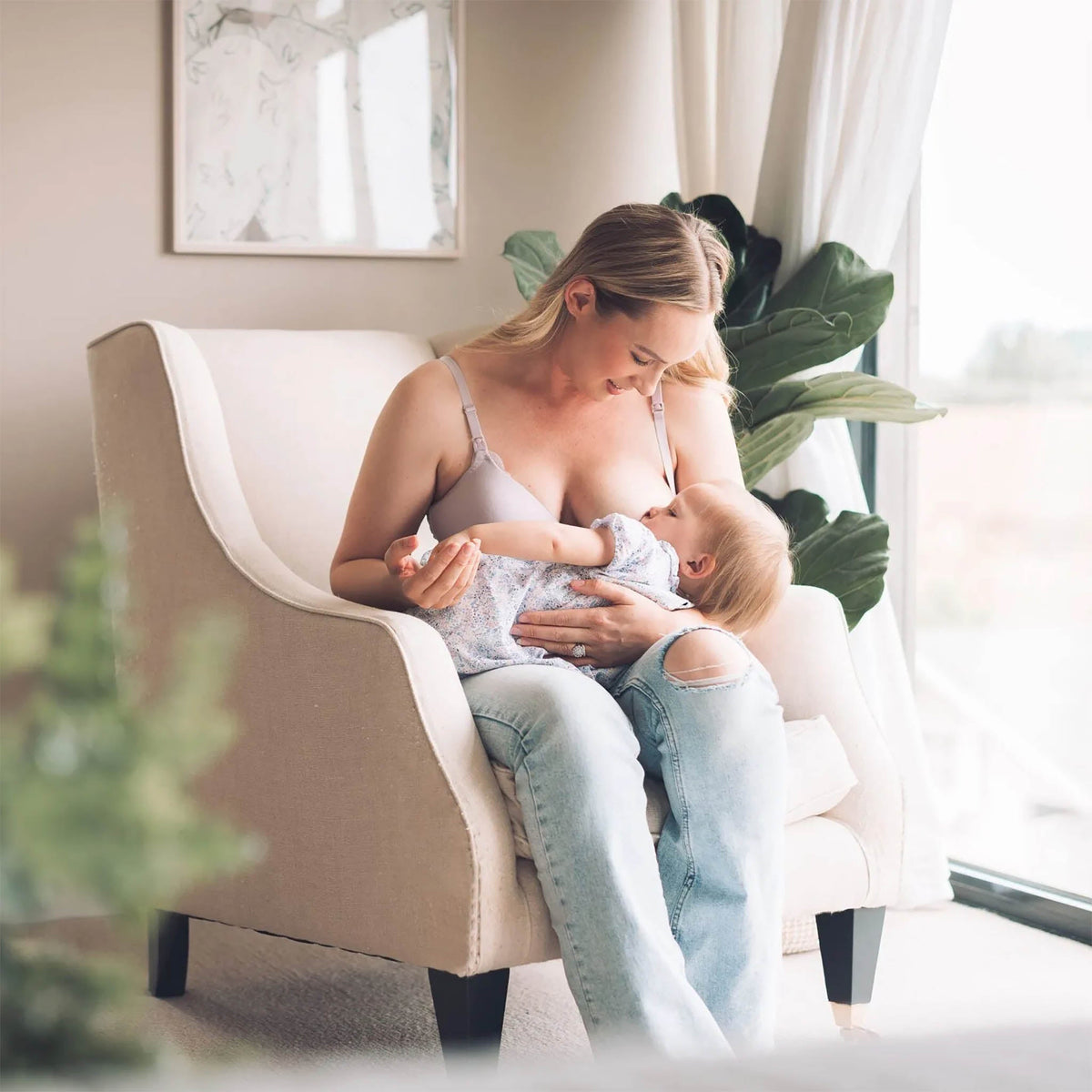 Mother nursing a baby using Belle Lacet nursing bras with clip-down cups and soft support