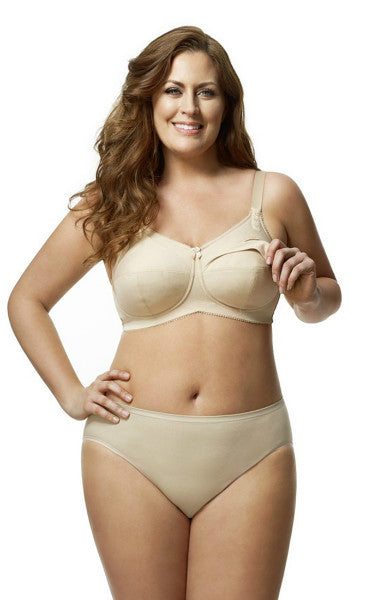 Woman wearing a beige bra and panties set on a white background