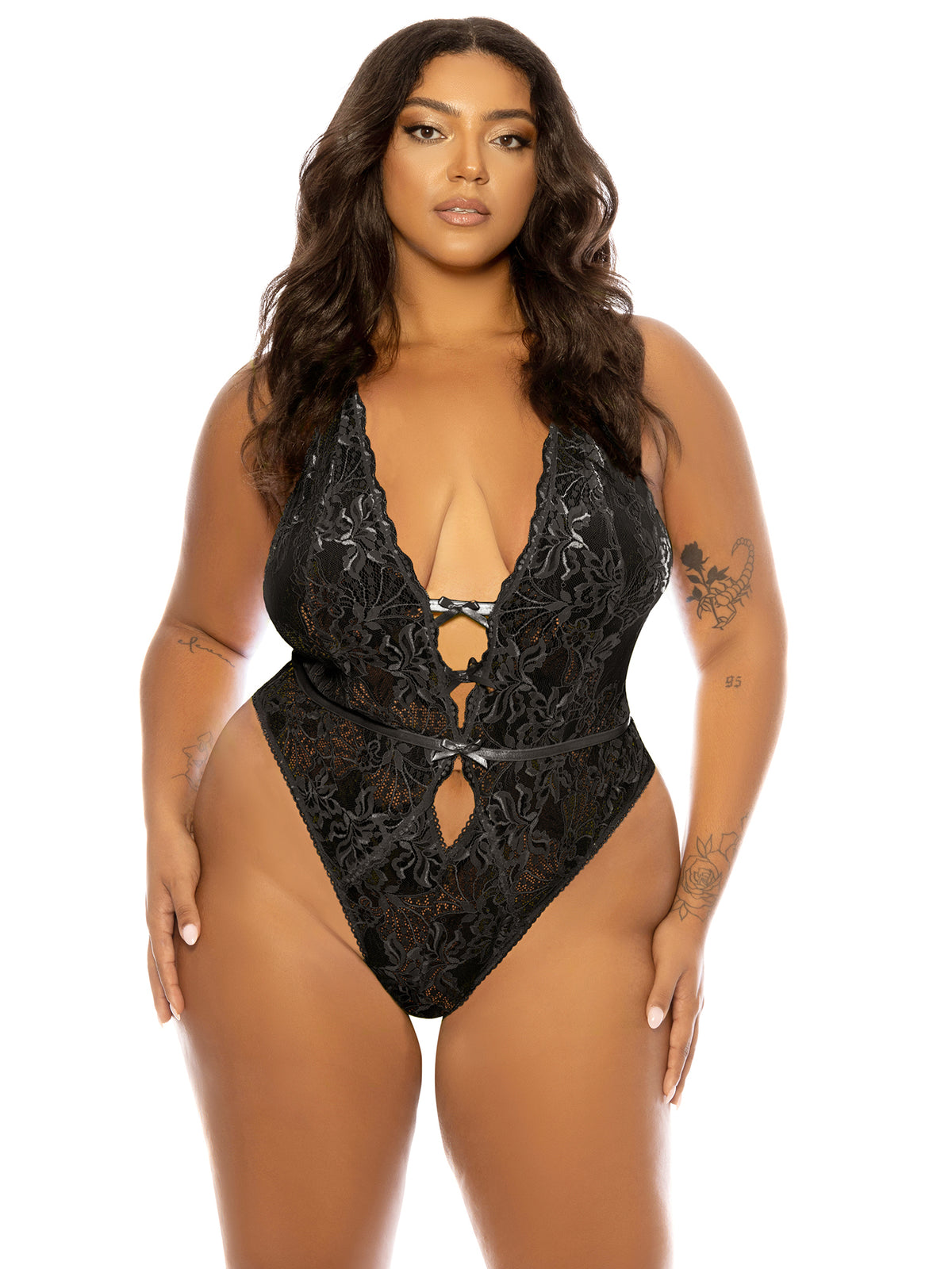 Woman wearing a black plus size 
Lauren lace teddy by Belle Lacet with soft cups, open gusset, and halter strap