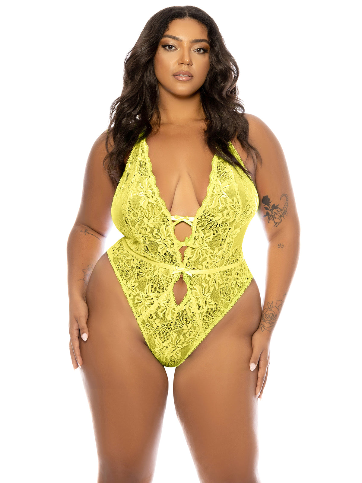 Woman wearing a yellow plus size Lauren lace teddy by Belle Lacet with soft cups, open gusset, and halter strap