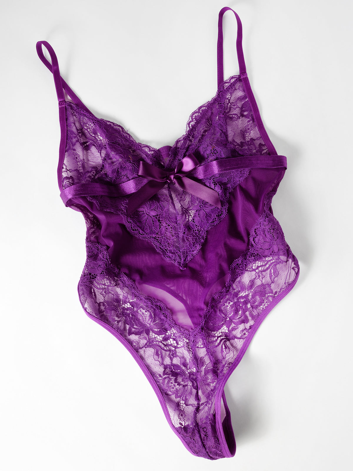 Flat lay of a Sylvie lace bodysuit in imperial purple with V front, high-cut legs, and thong back.