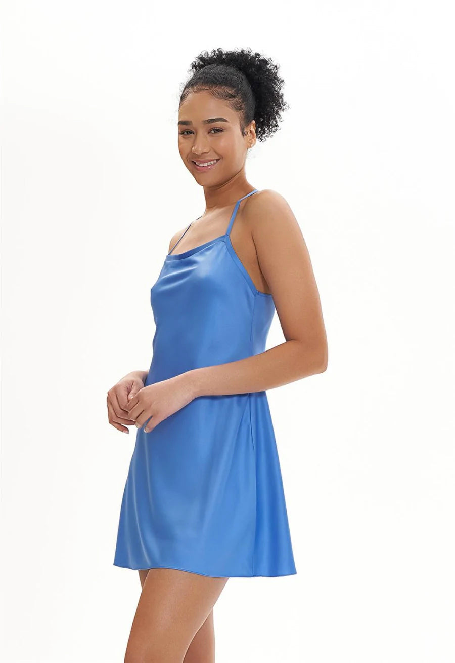 Woman wearing a blue satin nightgown on a white background