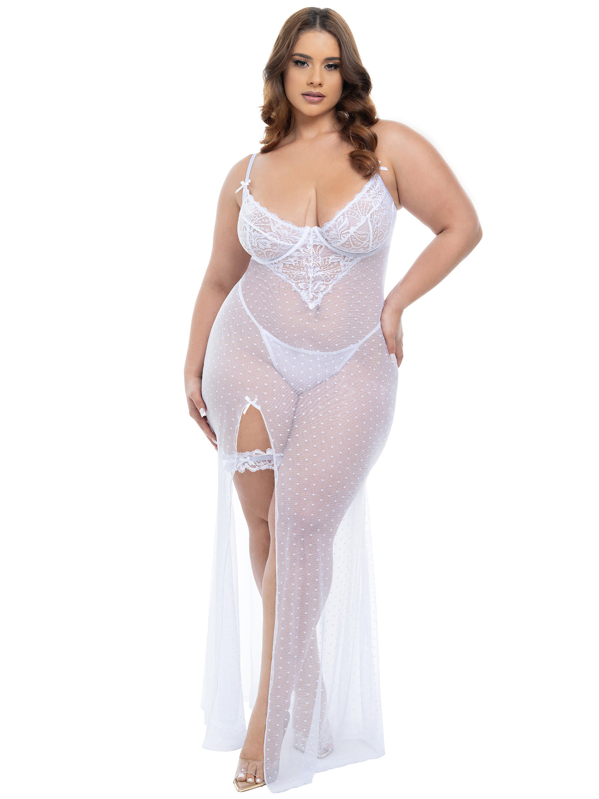 Woman wearing a plus-size sheer dot mesh bridal gown with lace inserts and matching lace garter