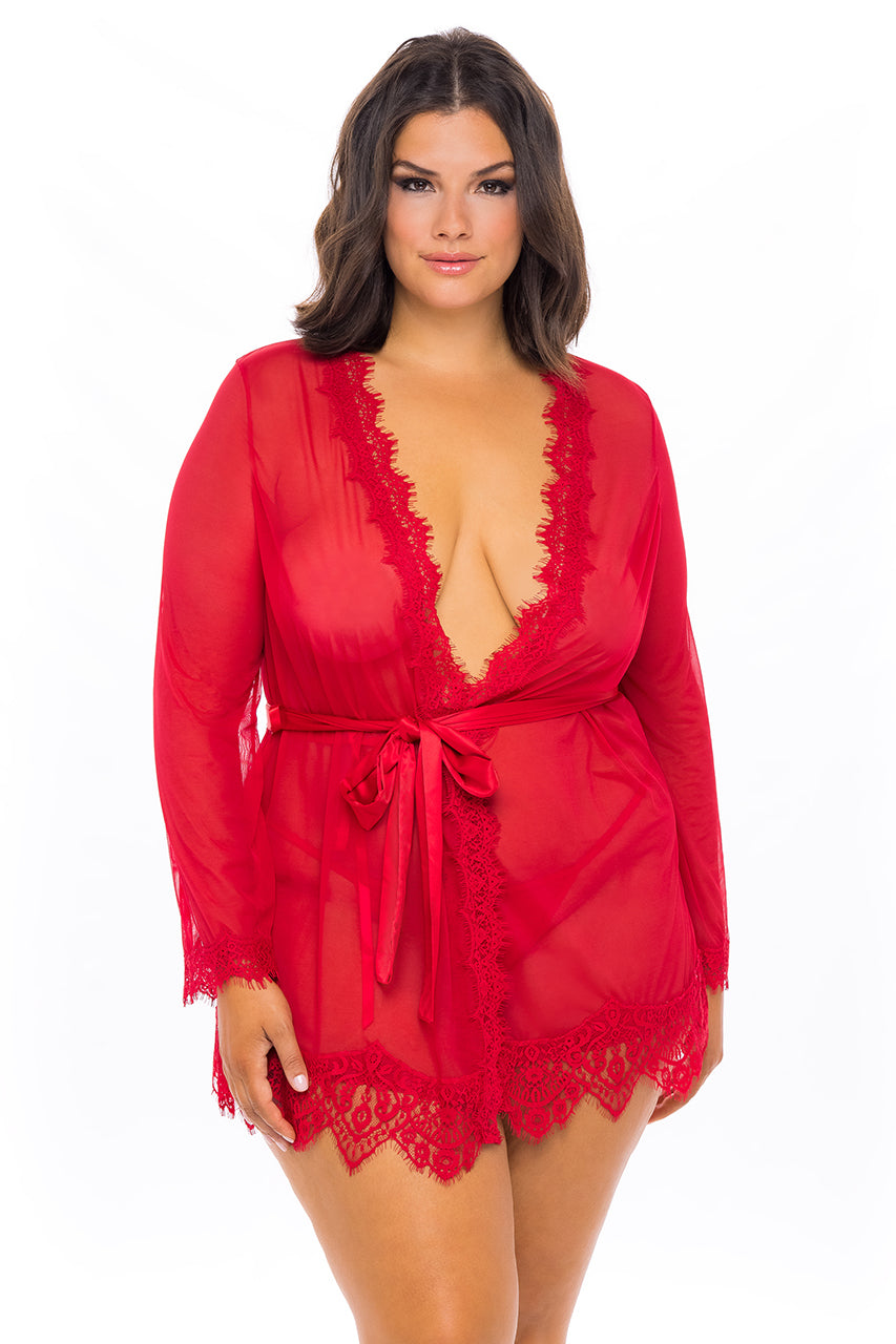 Woman wearing a red plus-size sheer mesh robe with lace trim, satin waist sash, and matching G-string