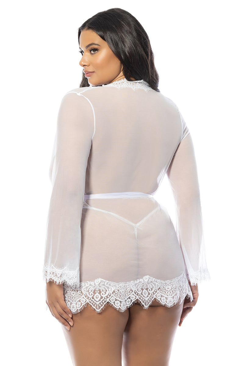 back view of a Woman wearing a white plus-size sheer mesh robe with lace trim, satin waist sash, and matching G-string.