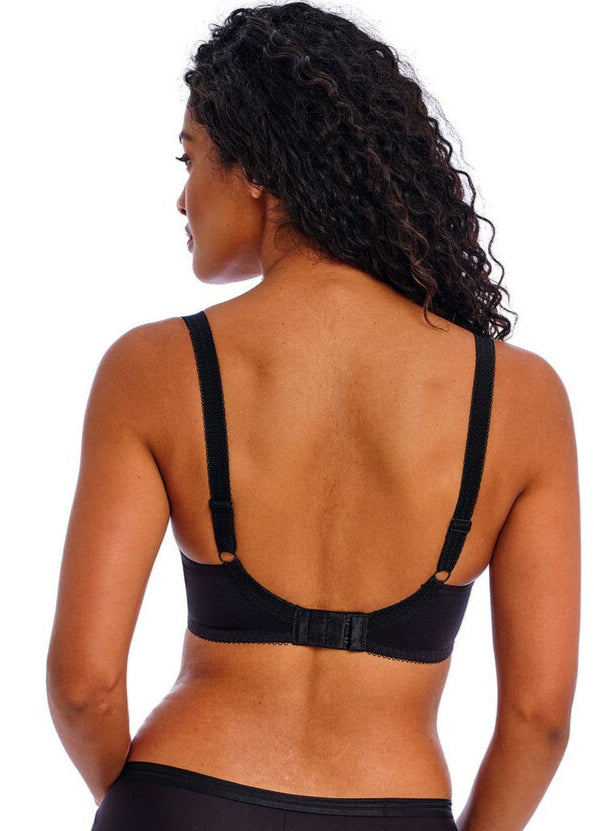 Person wearing a black bikini set on a white background