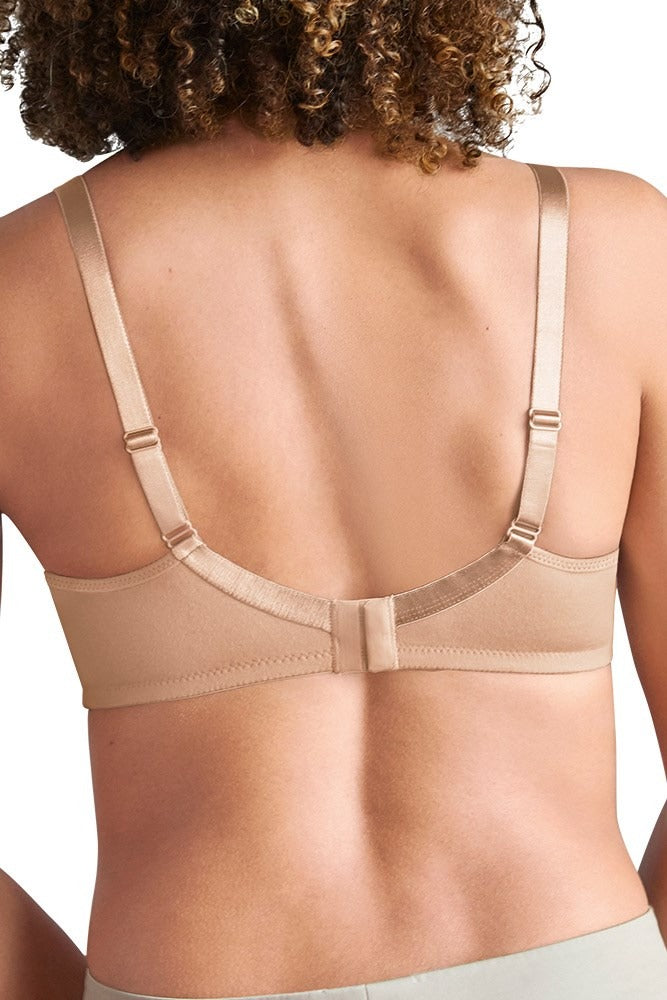 back view of a Woman wearing a beige wire-free soft cup bra with cotton pockets and adjustable straps for gentle support.