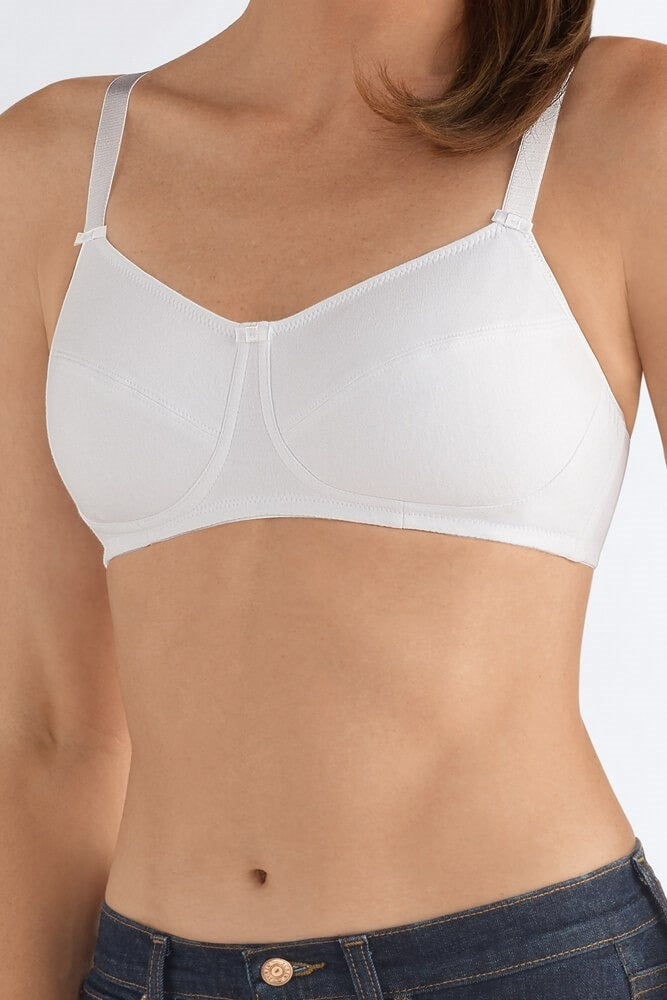 White bra worn by a person on a plain background