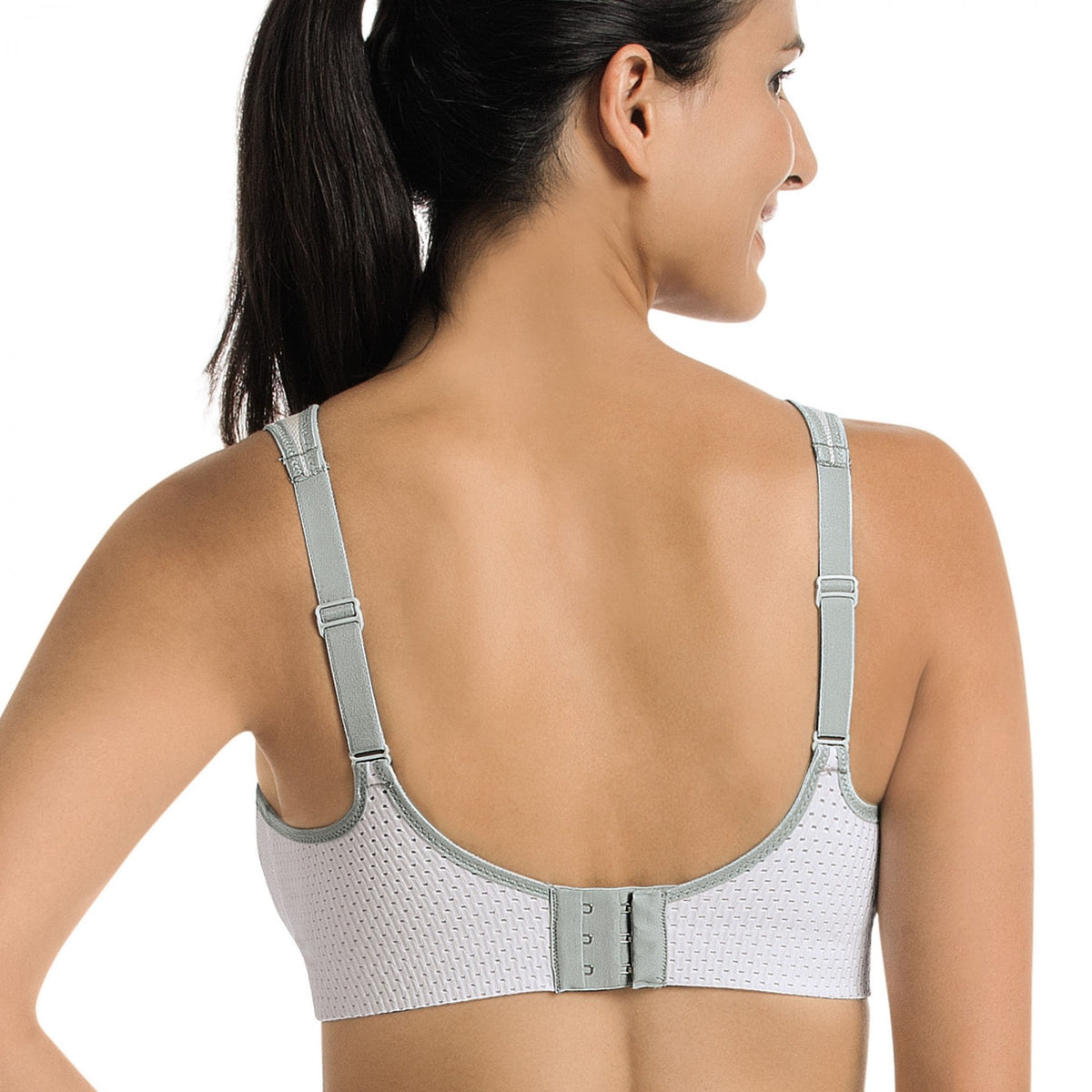 back view of a woman wearing a white Lightweight, breathable sports bra with patented DeltaPad cups and strong support for high-impact activity.