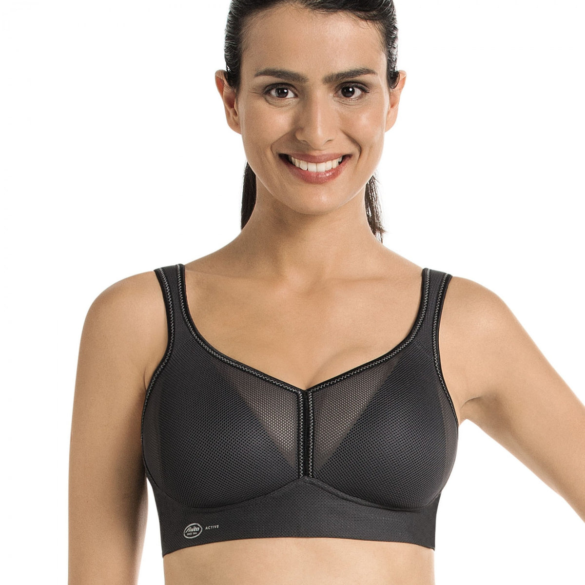 woman wearing a black Lightweight, breathable sports bra with patented DeltaPad cups and strong support for high-impact activity.