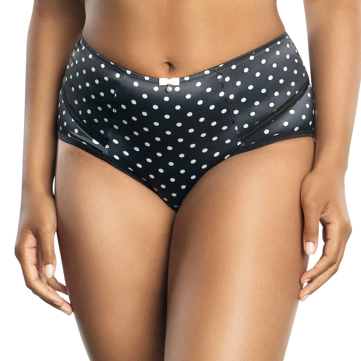 Woman wearing a black polka dot panty bottom on a white background