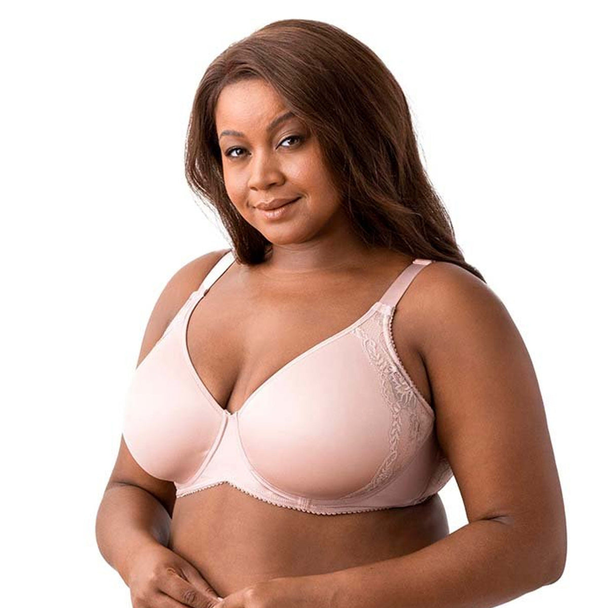 Woman wearing a light pink bra and panties set on a white background