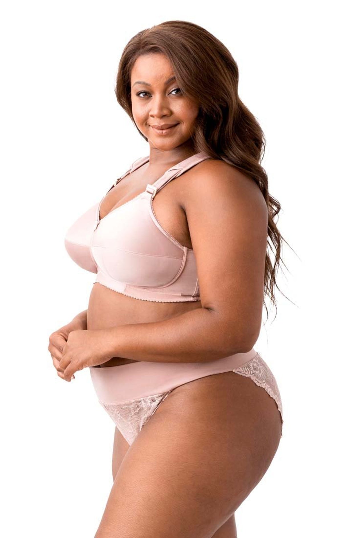 Woman wearing a pink bra and underwear set on a white background