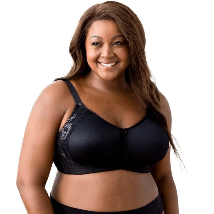 Woman wearing a black bra and panties set on a white background