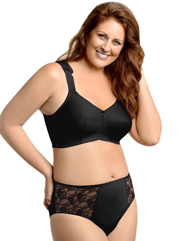 Woman wearing a black bra and lace underwear set on a white background