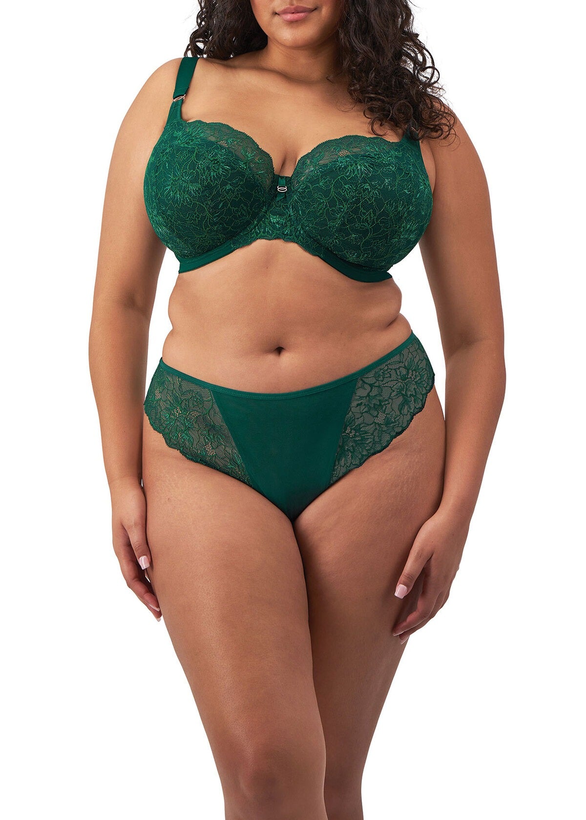 Woman wearing a green lace lingerie set on a white background
