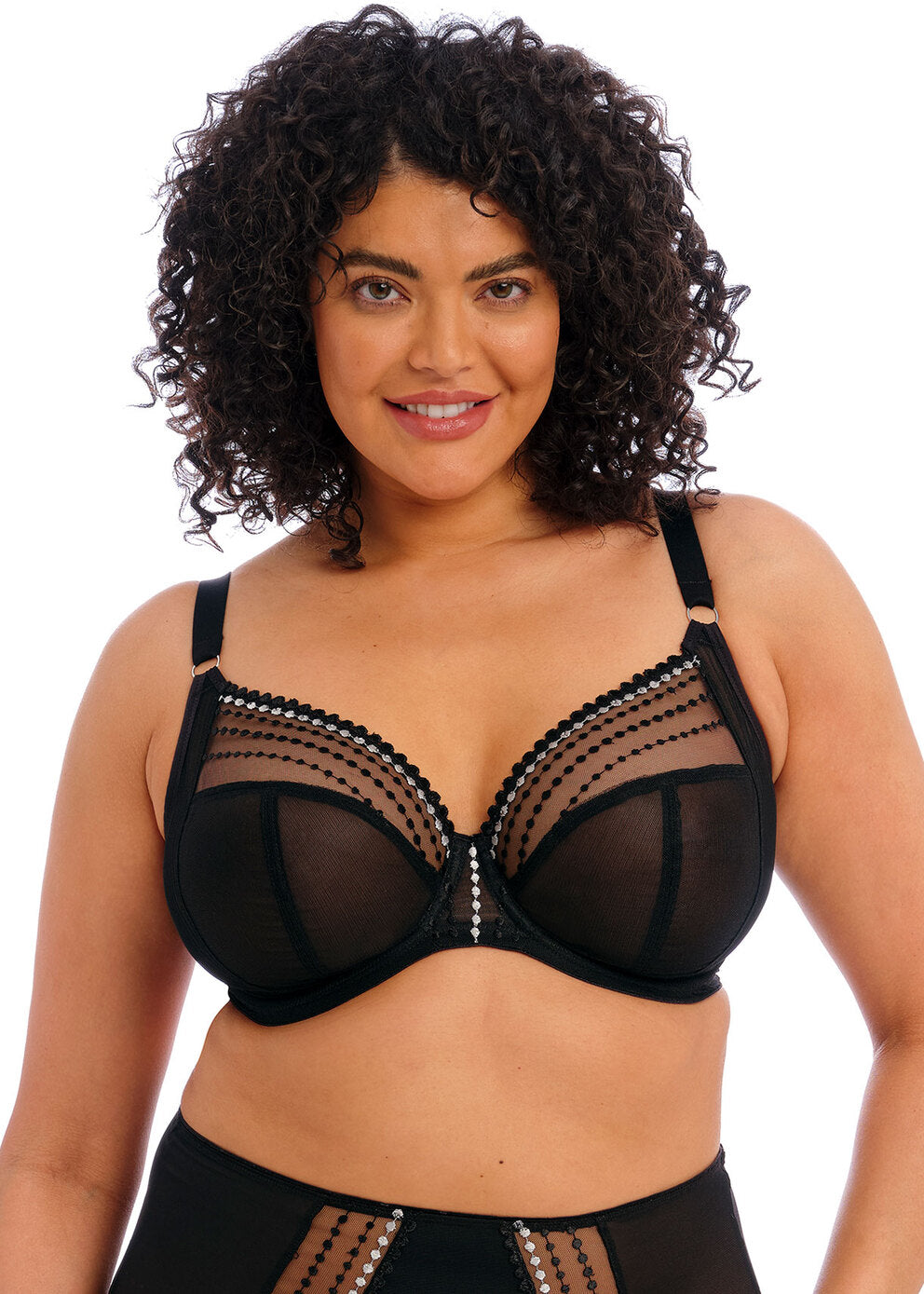 Woman wearing a black bra with mesh details on a white background