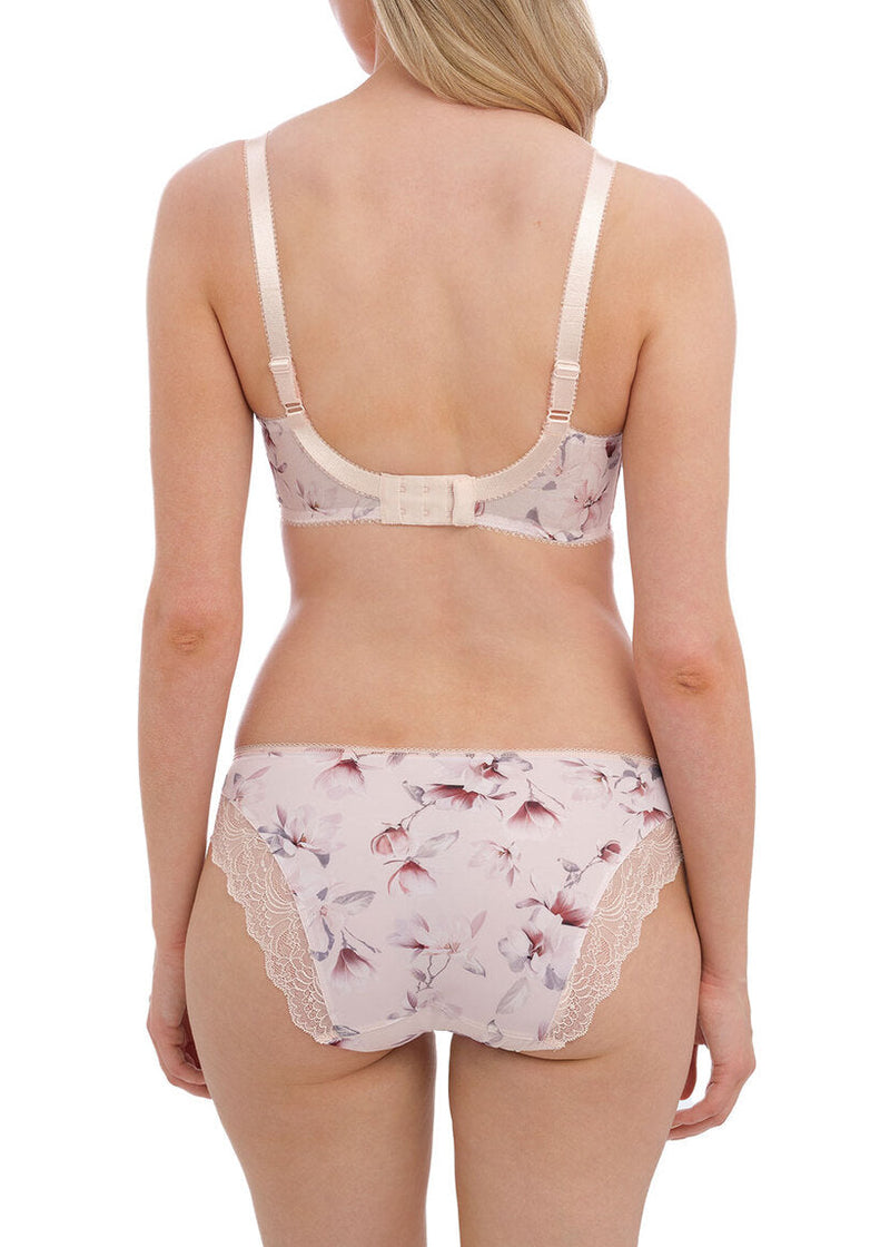 Woman wearing a floral lingerie set on a white background