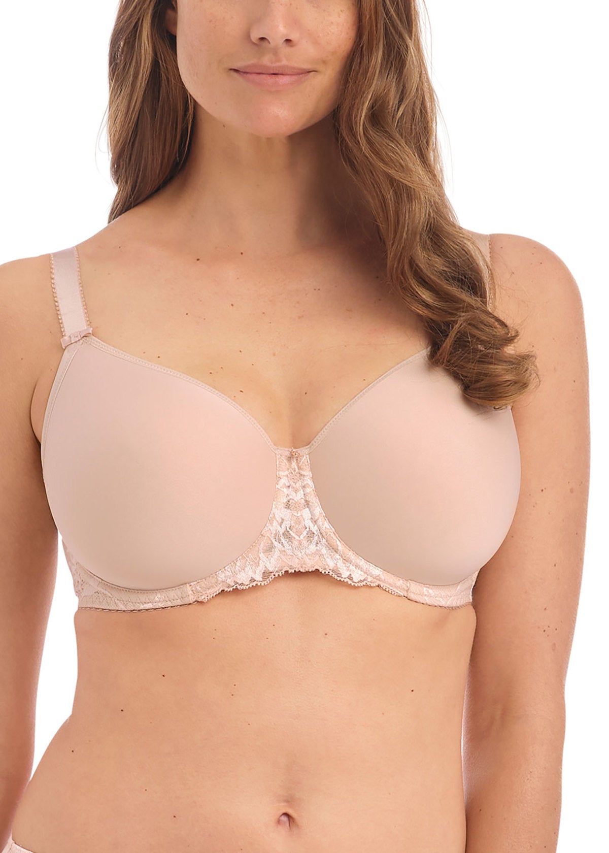 Woman wearing a beige bra with lace details on a white background