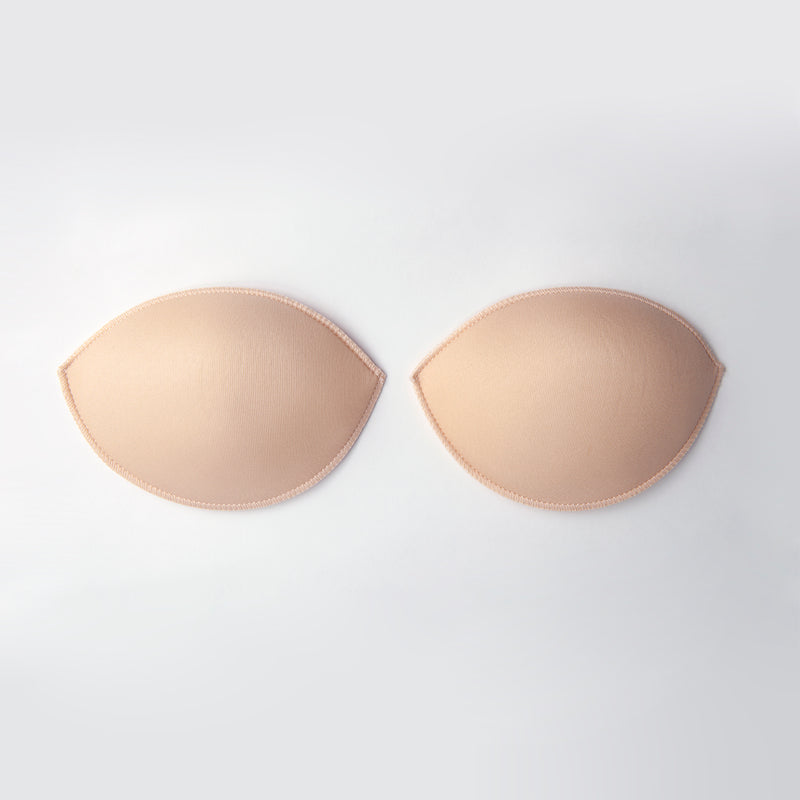 Beige bra pads on a white background