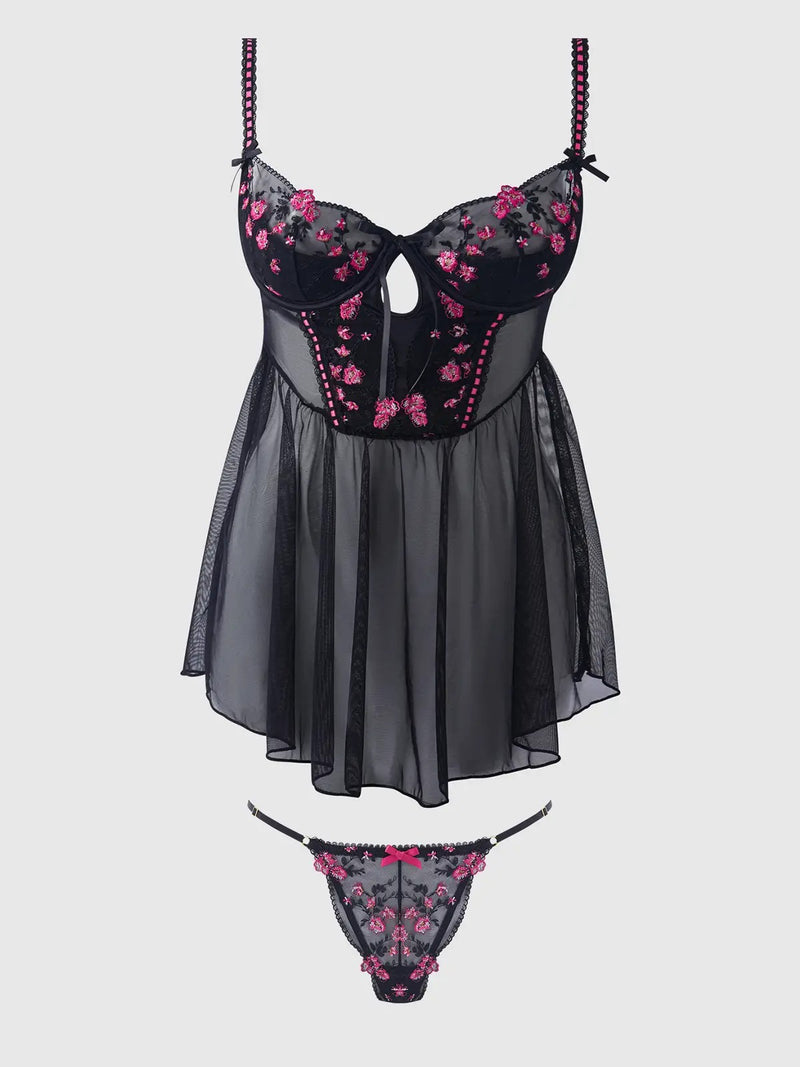 Black and pink floral lingerie set on a light gray background