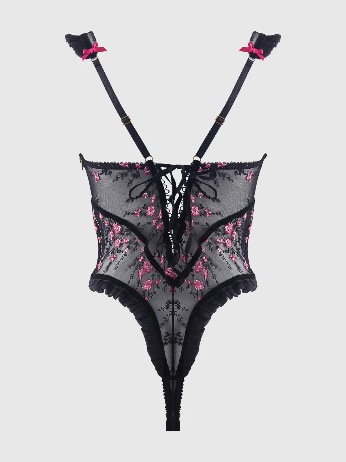 Black lace lingerie set with floral details on a light gray background