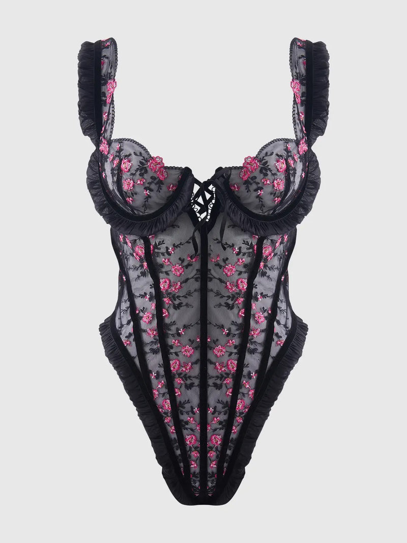 Floral lingerie set with black lace trim on a light gray background