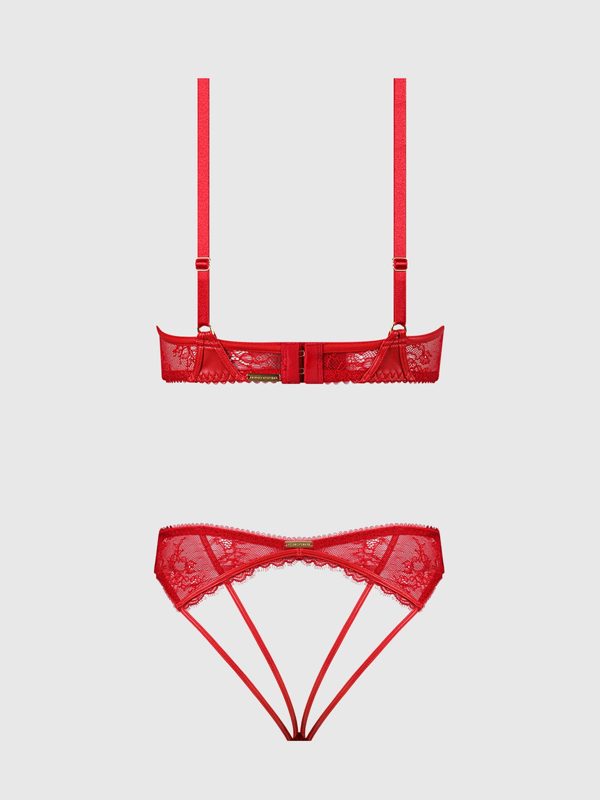 Red lace lingerie set featuring a strappy underwire bra and matching thong with a bow detail, displayed on a light gray background.
