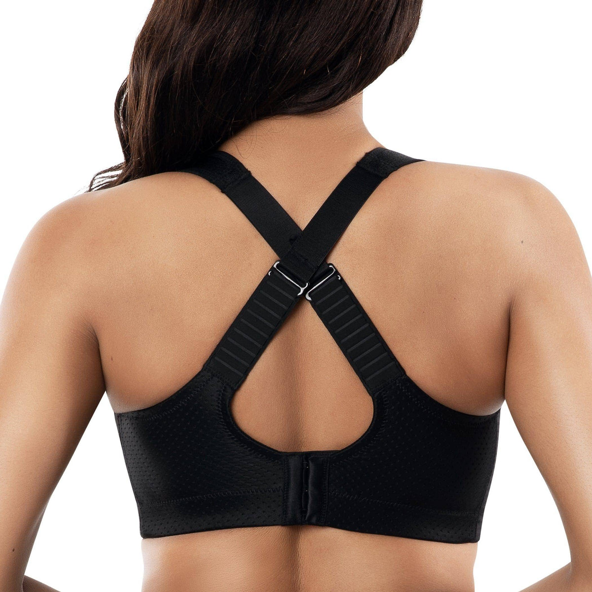 Black sports bra worn by a person on a white background