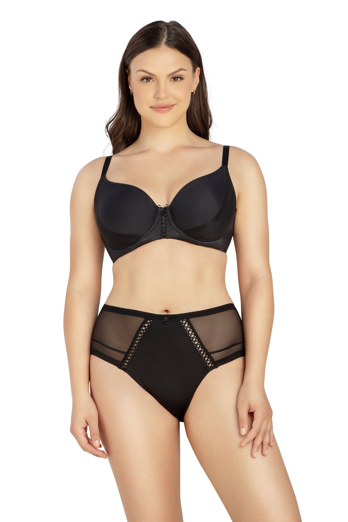 Woman wearing a black bra and high-waisted panties on a white background