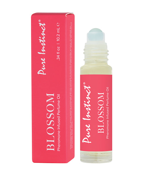 Pure Instinct Blossom perfume oil with packaging on a white background