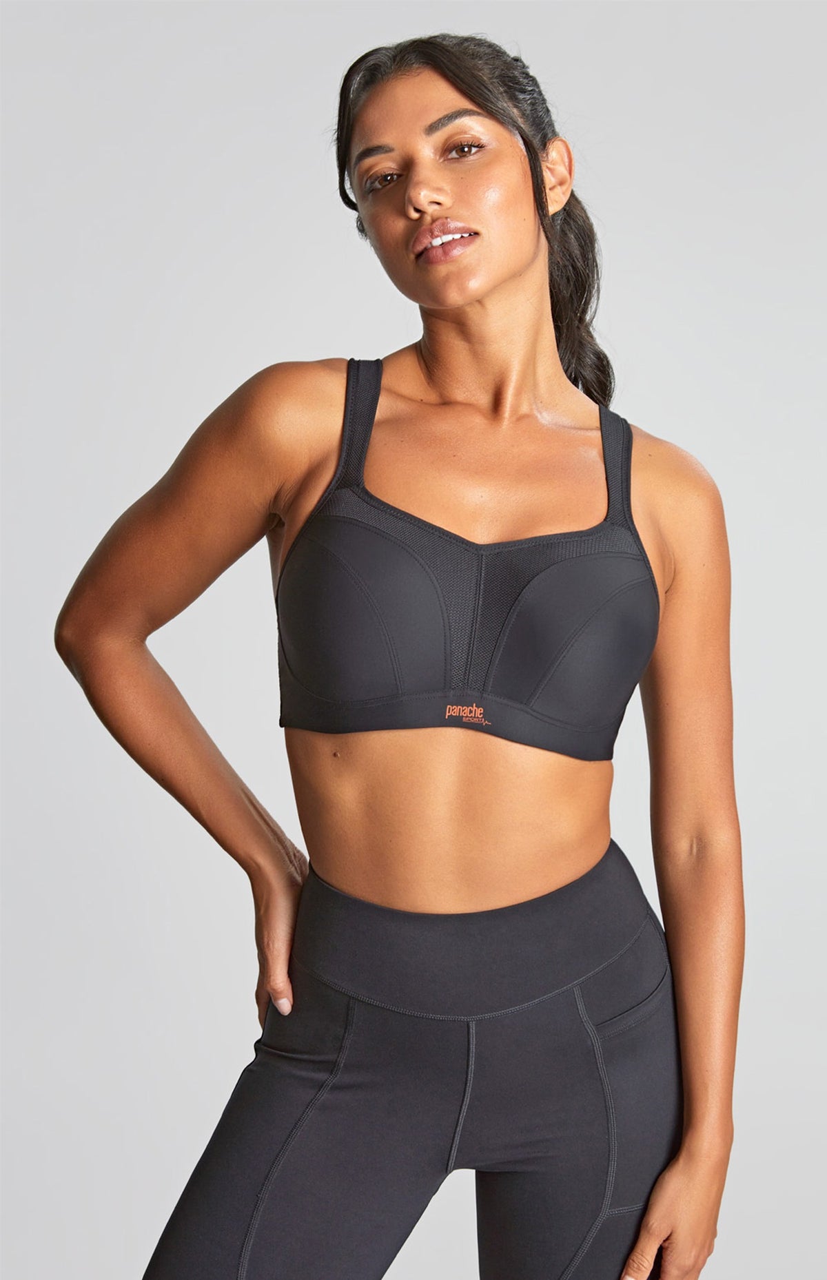 person in a black sports bra on a grey background
