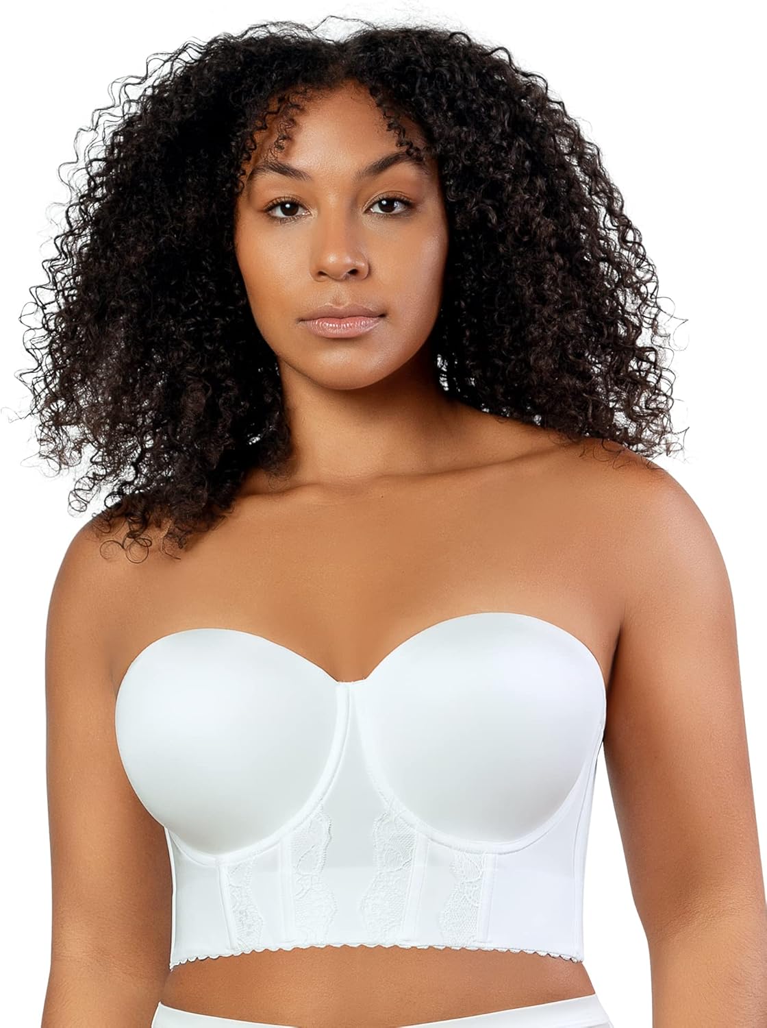 Woman wearing a white strapless bra against a plain background