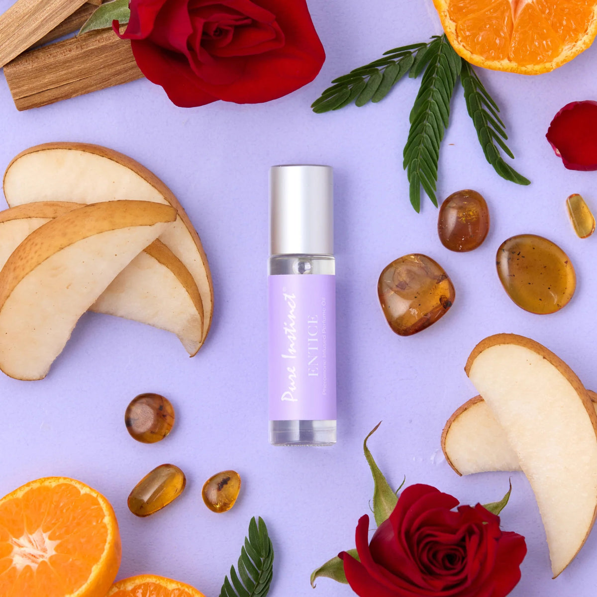 Perfume with natural ingredients like oranges, pears, and roses on a light purple background