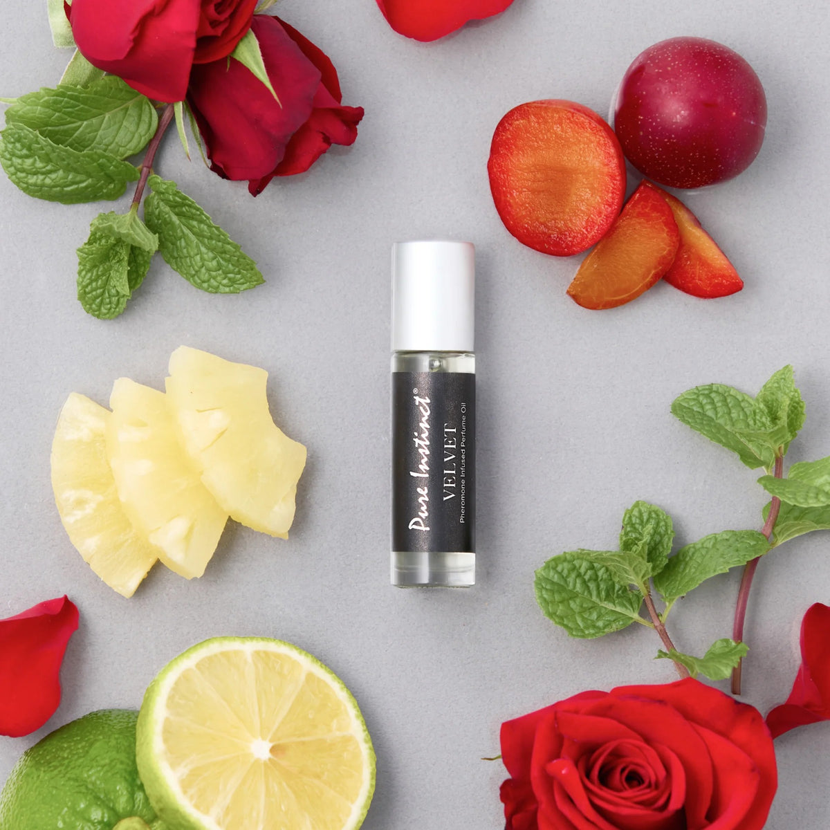 Skincare product with fruits and flowers on a light gray background