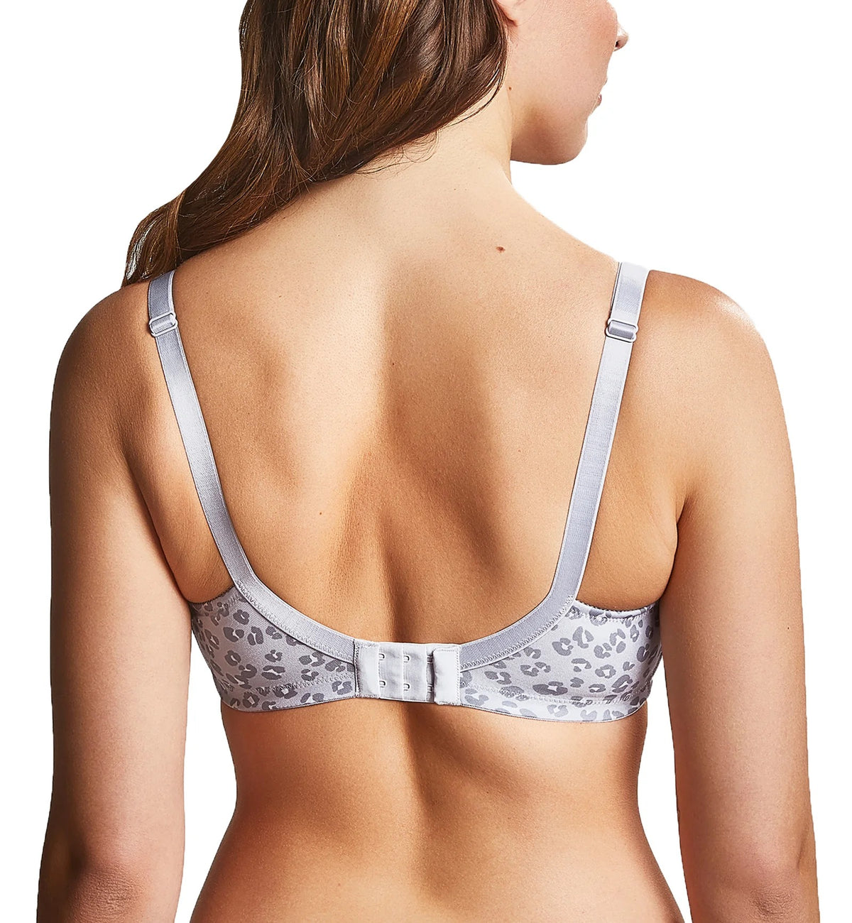 Woman wearing a patterned bralette on a white background