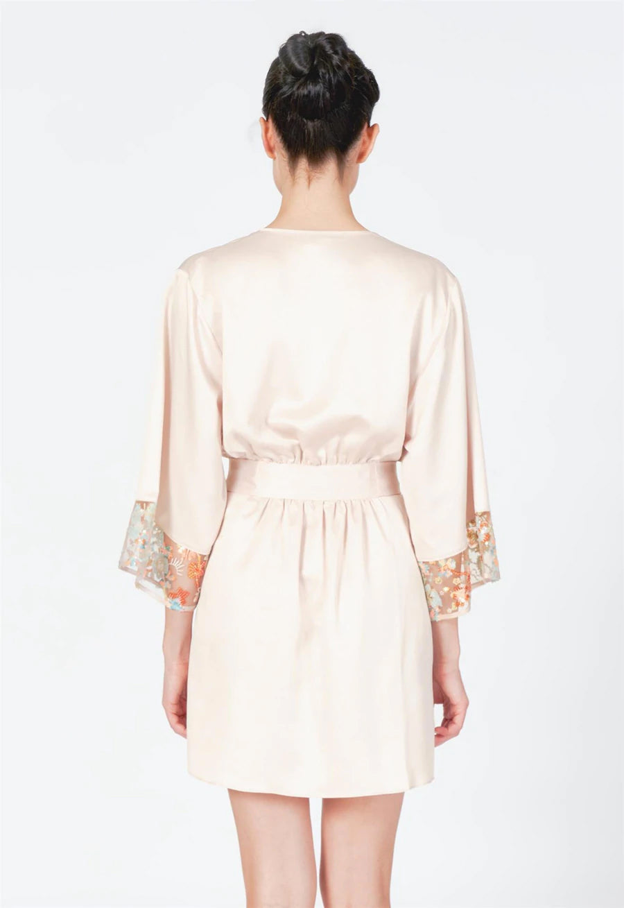 Beige dress with lace sleeves on a white background