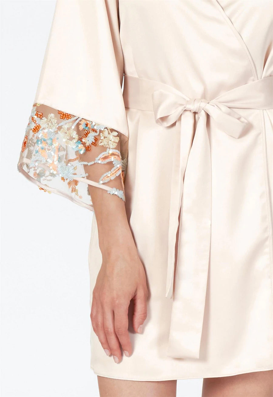 Light pink dress with floral cuffs on a white background