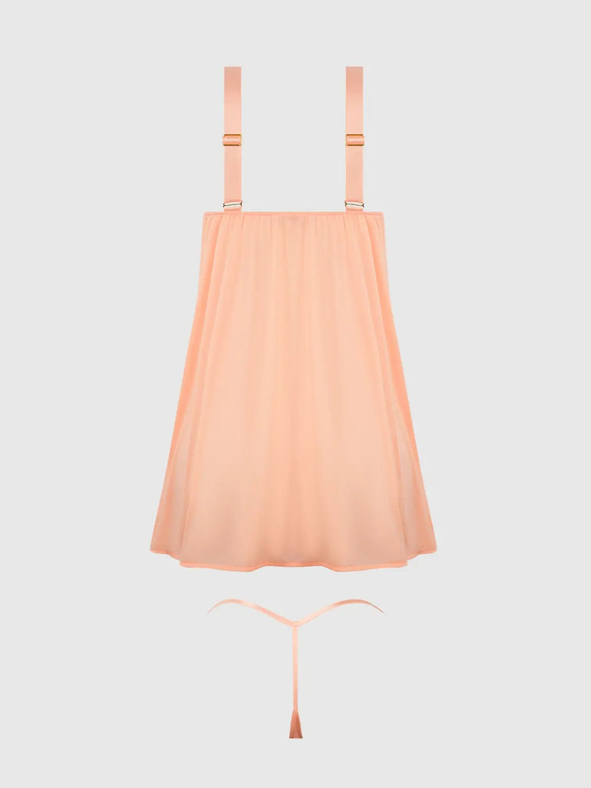 Peach-colored slip dress with thin straps on a light gray background