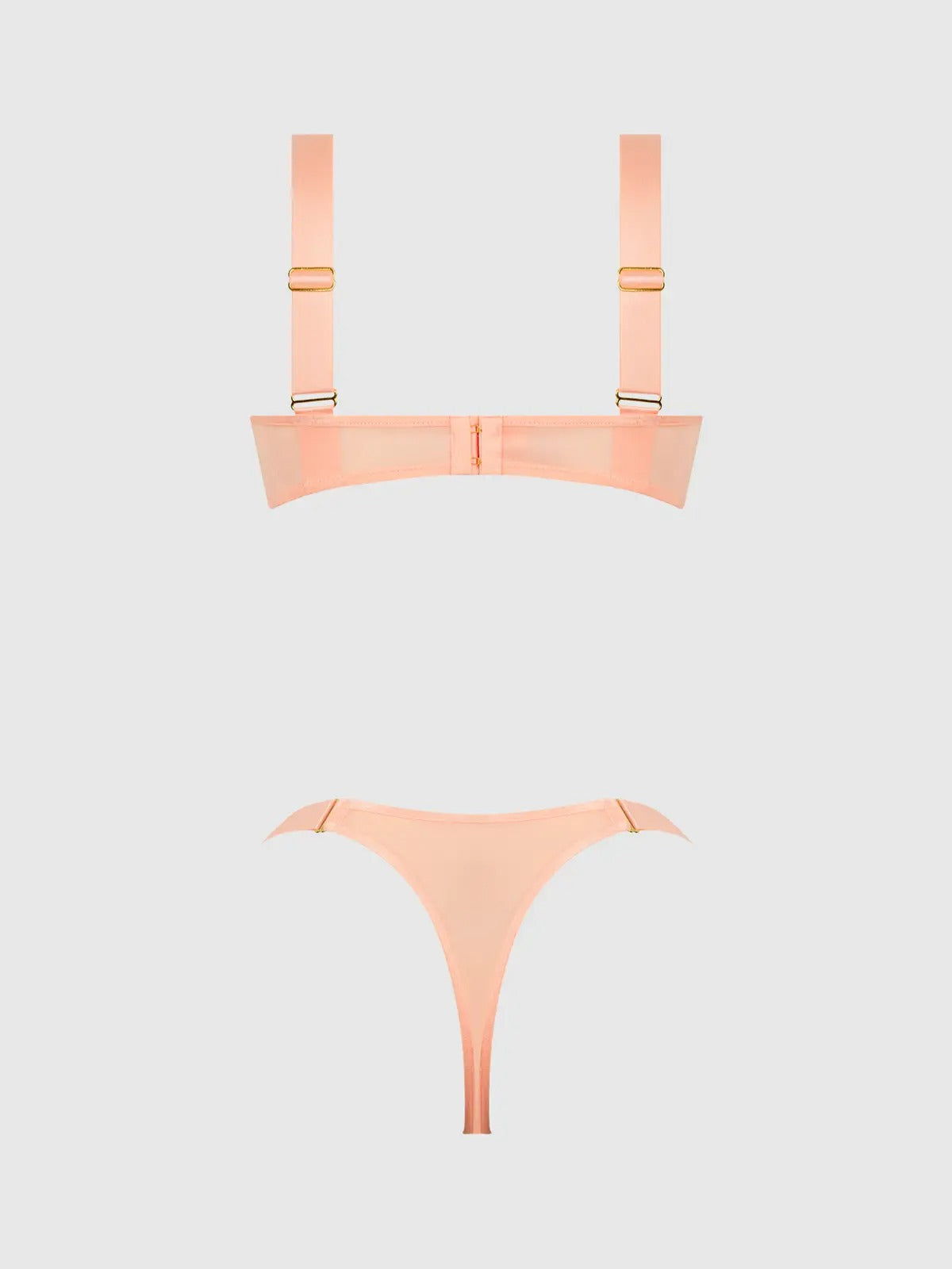 Peach colored bra set on a white background