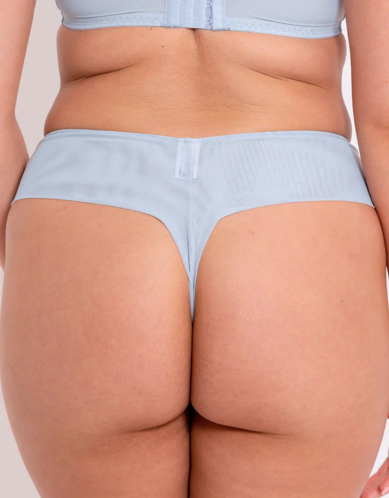 Light blue underwear worn by a person on a plain background