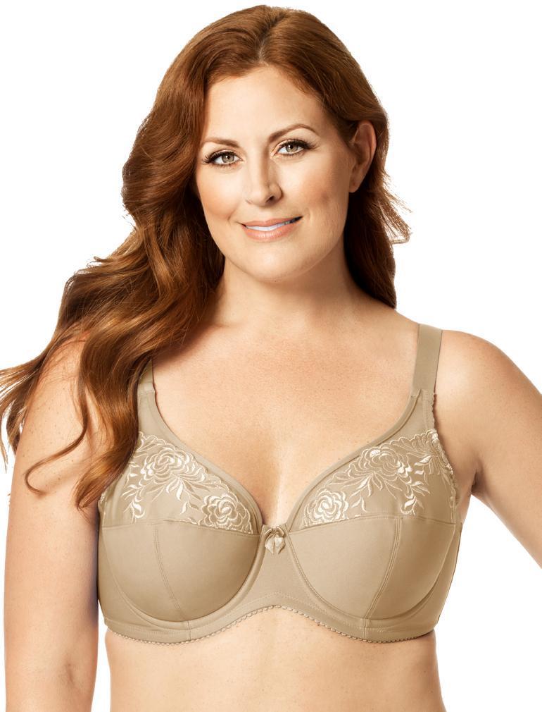 Woman wearing a beige bra with floral lace details on a white background