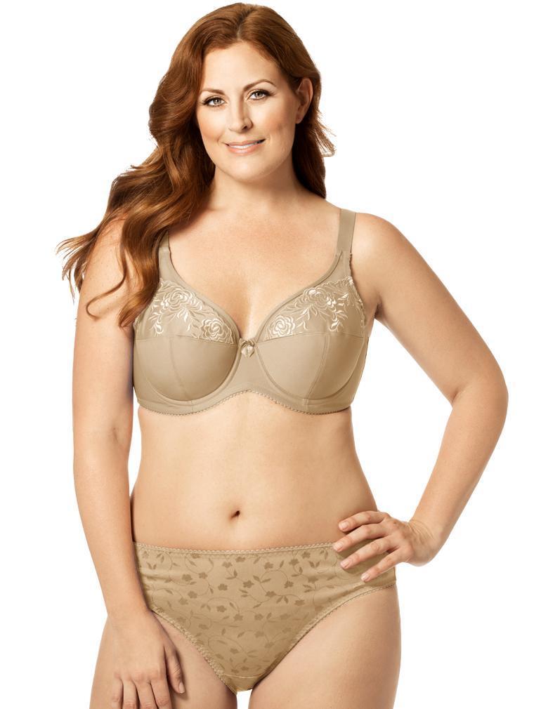 Woman wearing a beige bra and panties set on a white background