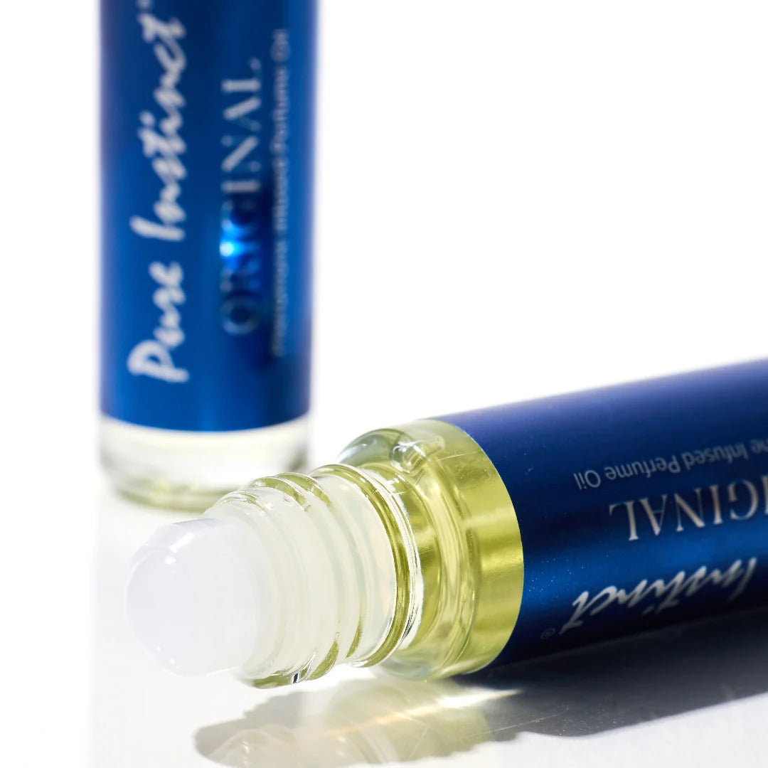 Roll-on perfume bottle with blue cap and clear body on a white background