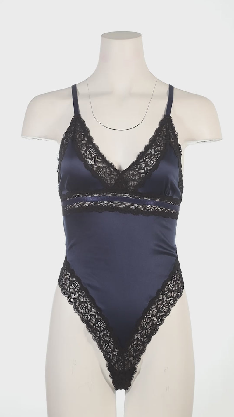 Mannequin wearing a blue lingerie set with black lace details in a gym setting