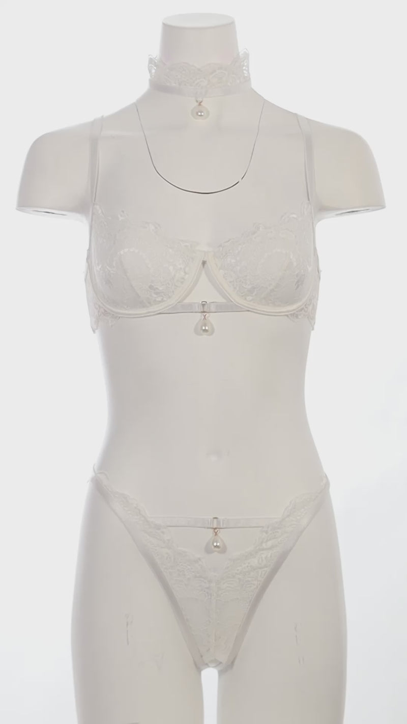Mannequin wearing a bridal lace bra set with pearl choker and open-back panty