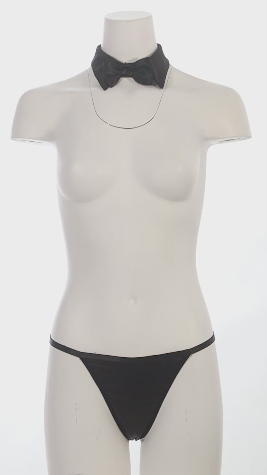 Mannequin with a bow tie collar and thong on a white background