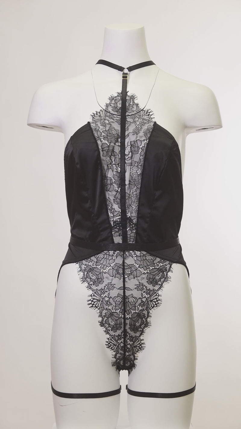 Mannequin wearing the Winnie Harness Lace Teddy featuring satin choker harness and lace body.
