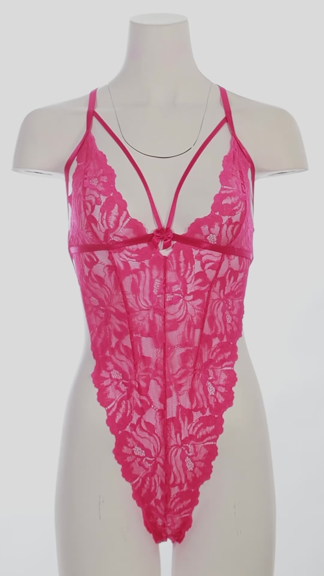 mannequin wearing a pink strappy bodysuit on a white background