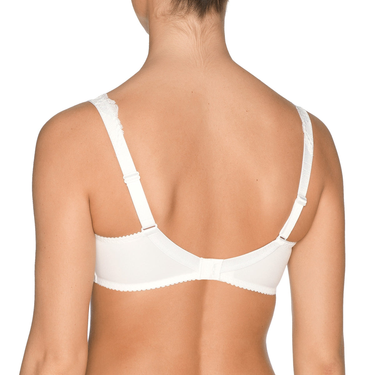 White bra worn by a person on a white background
